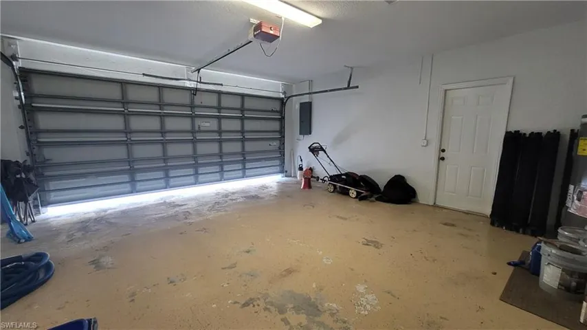 Garage with electric panel and a garage door opener
