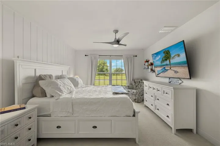 Carpeted bedroom with ceiling fan
