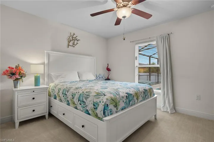 Bedroom with light carpet and ceiling fan