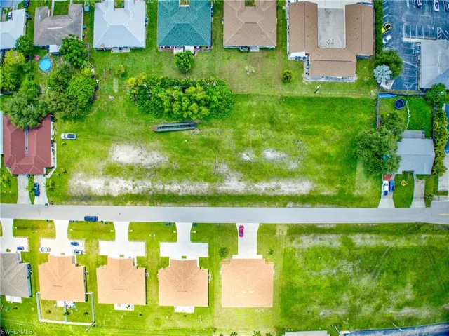Aerial view of property and surrounding area with nearby suburban area