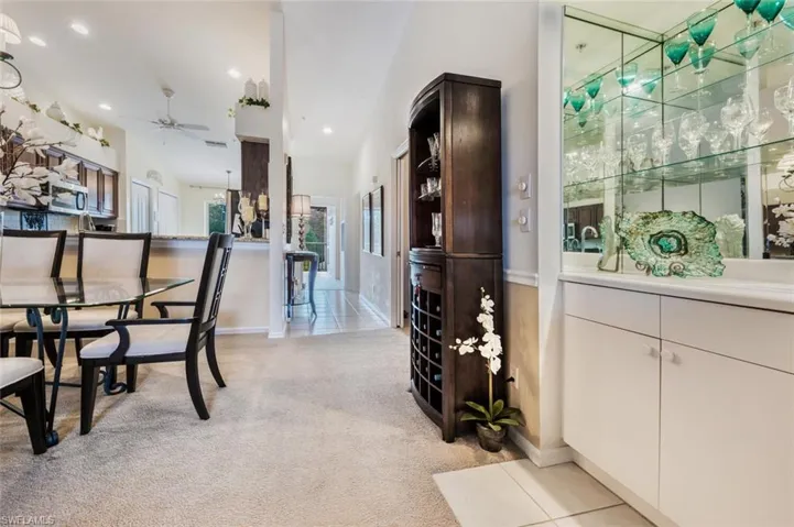 Dining room with light colored carpet, recessed lighting, and ceiling fan