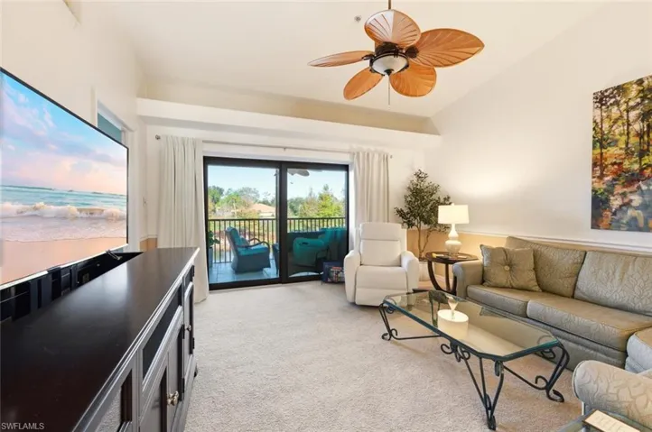 Living room with light carpet and ceiling fan