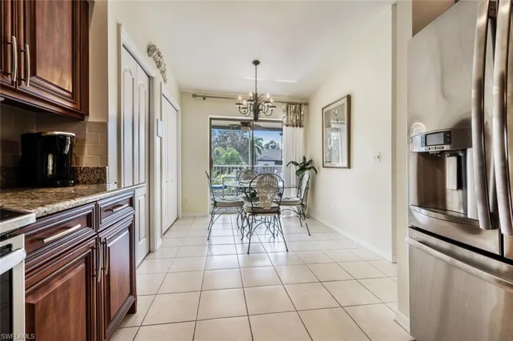 Dining space featuring light tile patterned flooring and a chandelier