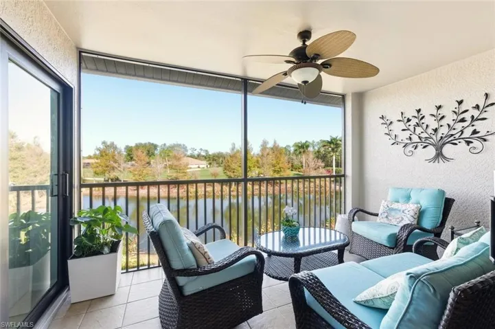 Sunroom / solarium with a balcony, outdoor lounge area, a water view, and a ceiling fan