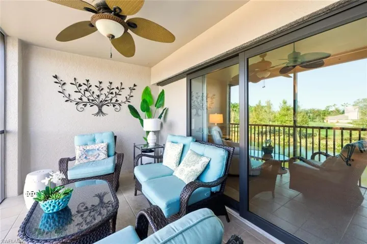 Sunroom / solarium with a ceiling fan, an outdoor living space, and a balcony
