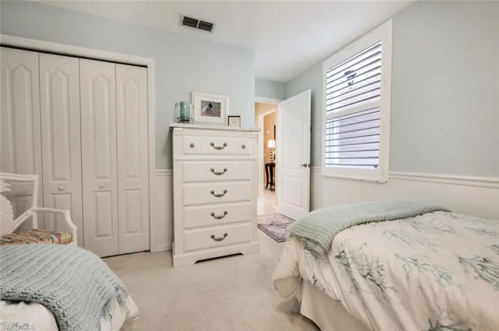 Bedroom featuring a closet and light carpet
