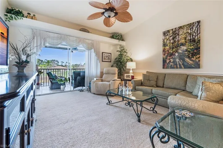 Living area featuring carpet flooring and a ceiling fan