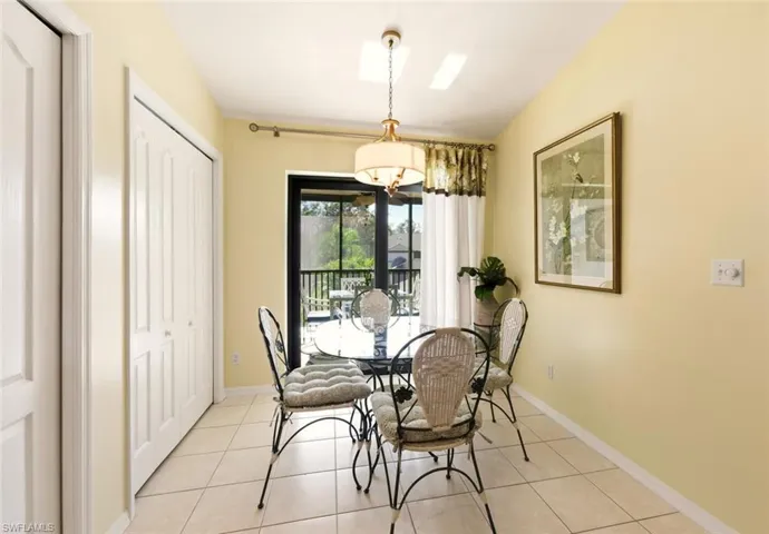 Dining room featuring light tile patterned floors and baseboards