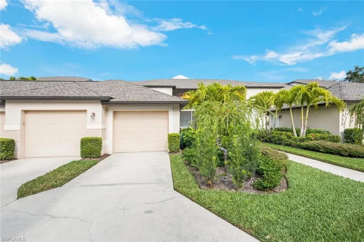 View of front of property featuring stucco siding, a shingled roof, concrete driveway, and a front yard