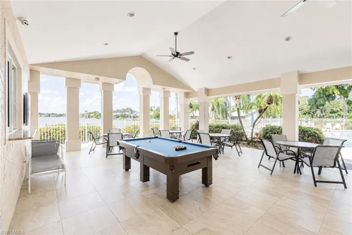 Covered outdoor patio featuring a vaulted ceiling and tile flooring