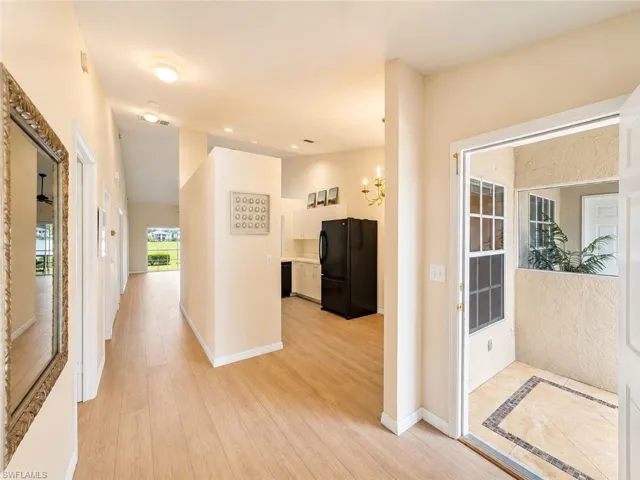 Spacious entryway featuring light wood-finish flooring, recessed lighting, and an open concept layout