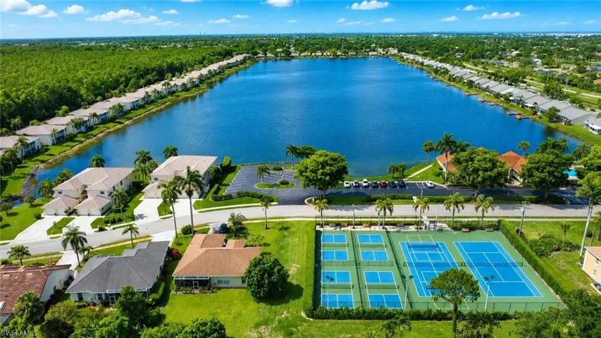 Expansive lakefront community featuring multiple tennis courts, pickleball courts, and a large central lake