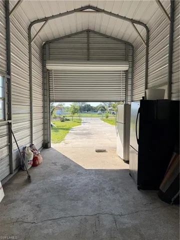 Garage with metal wall and fridge