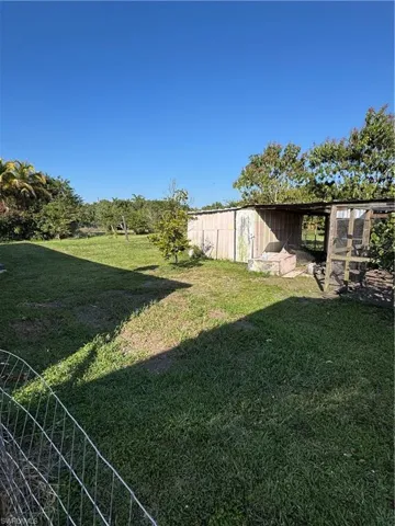 View of yard featuring an outdoor structure and exterior structure
