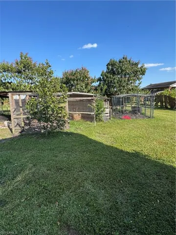 View of yard with exterior structure and an outdoor structure