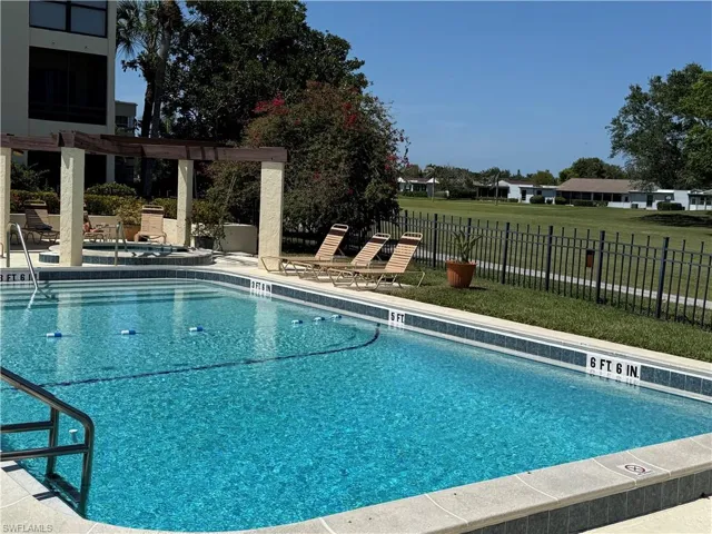 Community pool featuring a pergola