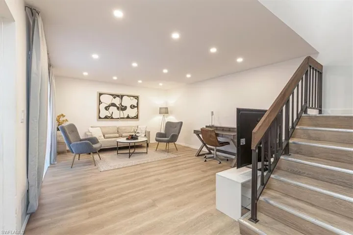 Living area with light wood-type flooring, recessed lighting, and an office area