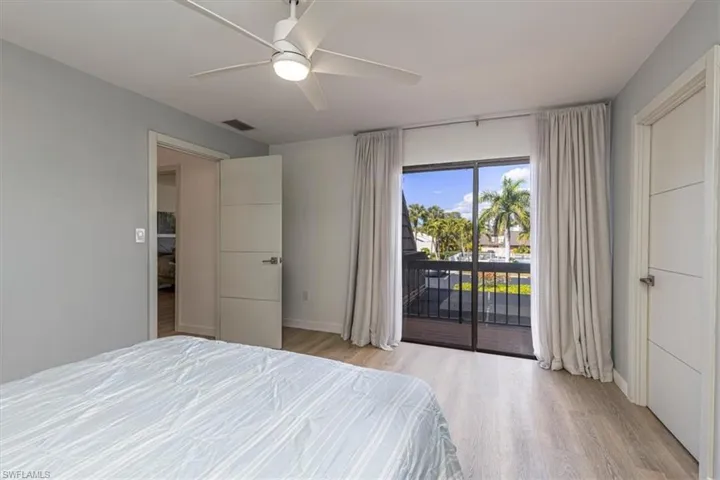 Bedroom featuring access to outside, a ceiling fan, and light wood-style flooring