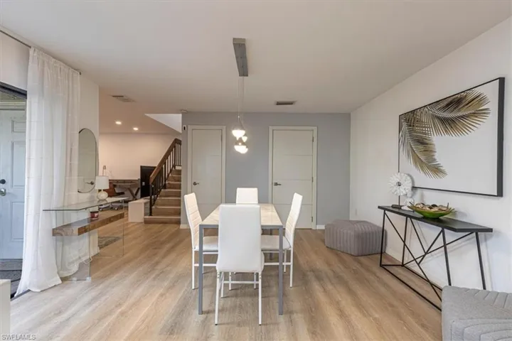Dining room with light wood-style floors and recessed lighting