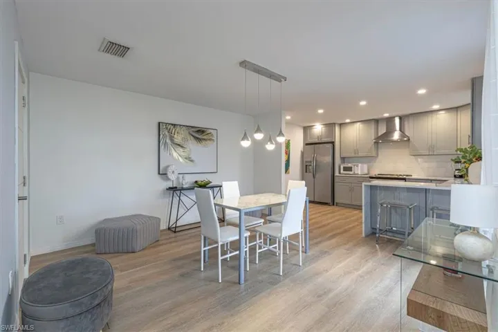Dining space featuring light wood finished floors and recessed lighting