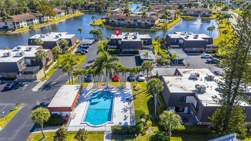 Aerial overview of property's location with a nearby body of water and a pool