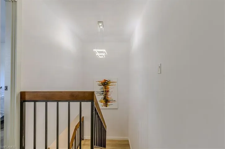 Staircase featuring wood finished floors and baseboards