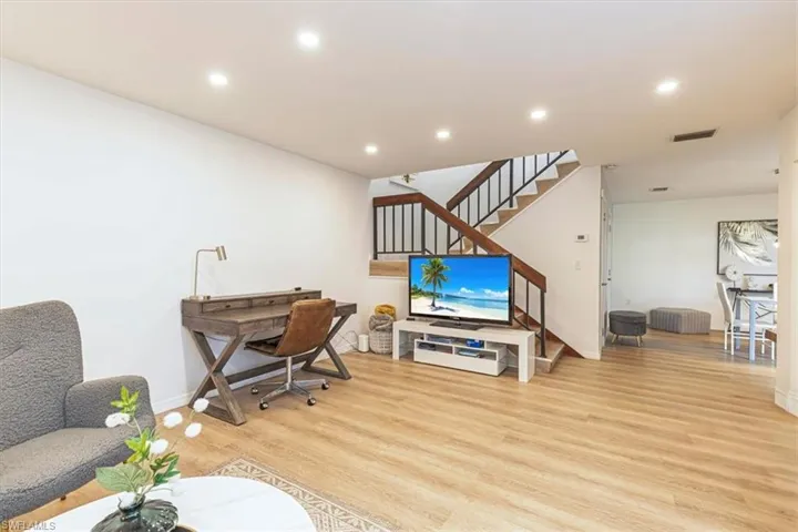 Office space featuring light wood finished floors and recessed lighting