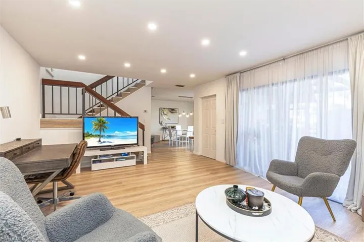 Living area featuring light wood-style flooring and recessed lighting