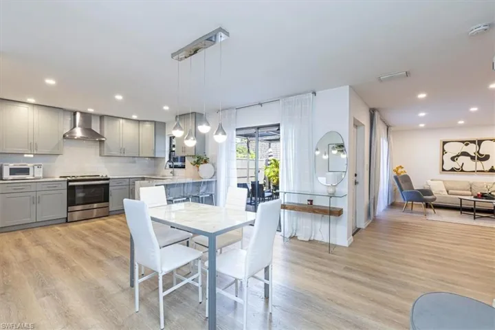 Dining room with recessed lighting and light wood-type flooring