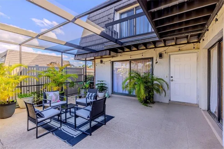 Patio / terrace with a patio, outdoor seating, glass enclosure, and a sunroom