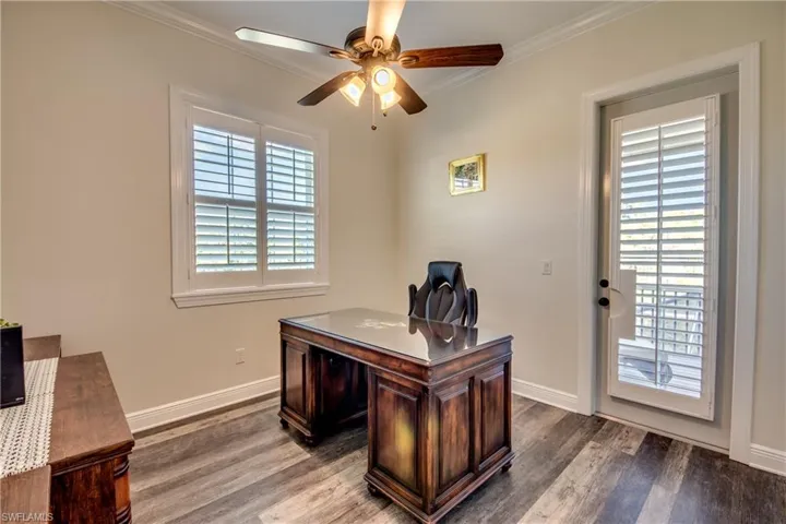 Home office featuring ceiling fan, hardwood / wood-style floors, and crown molding