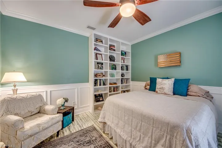 Bedroom featuring ornamental molding and ceiling fan