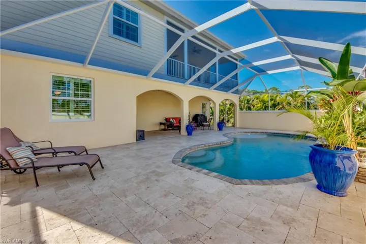 View of pool with a patio area and a lanai
