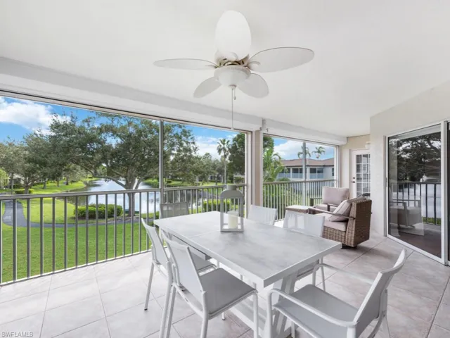 Sunroom featuring a water view and ceiling fan