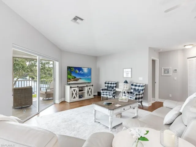 Living room featuring light wood-type flooring and ceiling fan