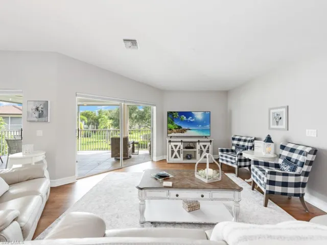 Living room with hardwood / wood-style flooring and a healthy amount of sunlight