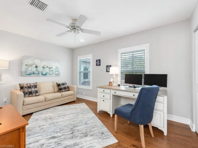 Office space with ceiling fan and hardwood / wood-style floors