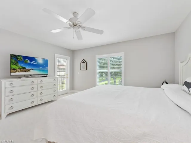 Bedroom featuring ceiling fan and carpet flooring