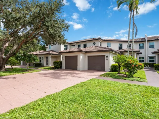 Mediterranean / spanish-style home featuring a front yard and a garage