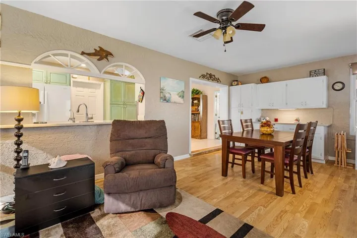 Dining area with ceiling fan, sink, and light hardwood / wood-style floors
