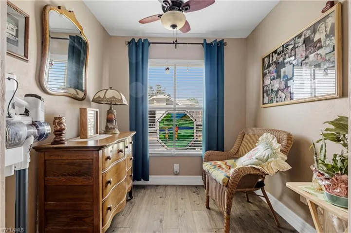 Sitting room featuring ceiling fan and light hardwood / wood-style floors