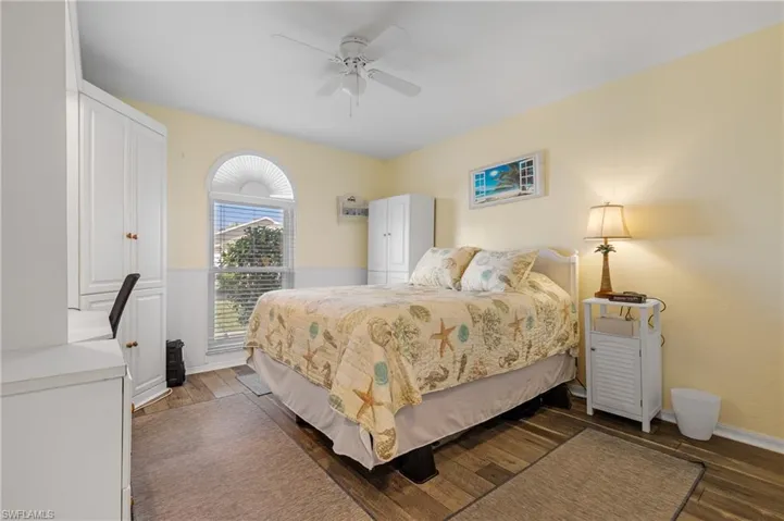 Bedroom featuring ceiling fan and dark hardwood / wood-style flooring