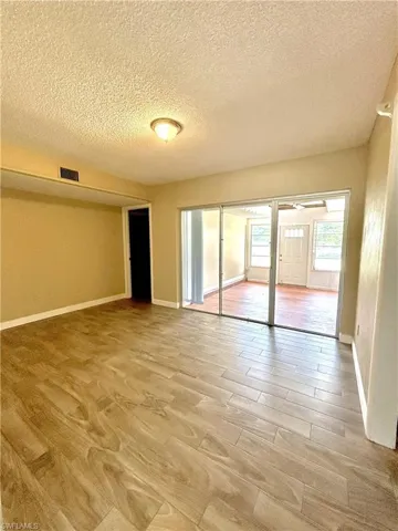 Dining room looking to rear sunroom and door to master bedroom