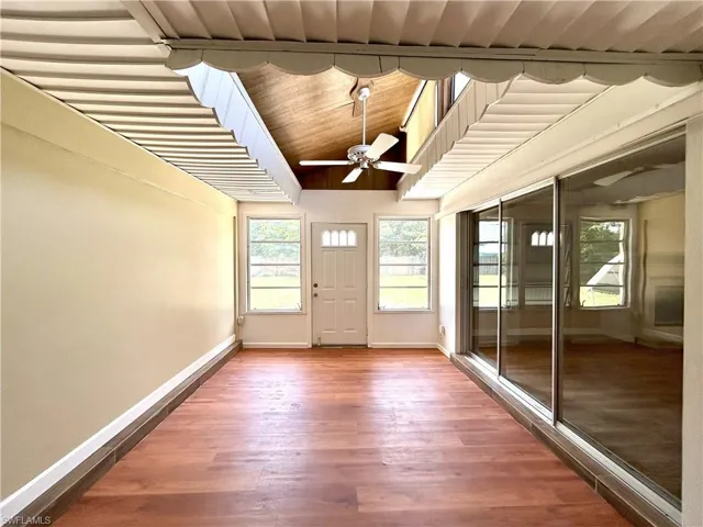 Sunroom looking from sliders to formal dining room