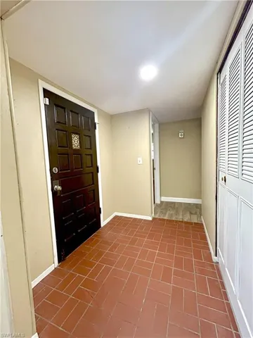 Front Entry with Coat Closet with view to Guest Hallway