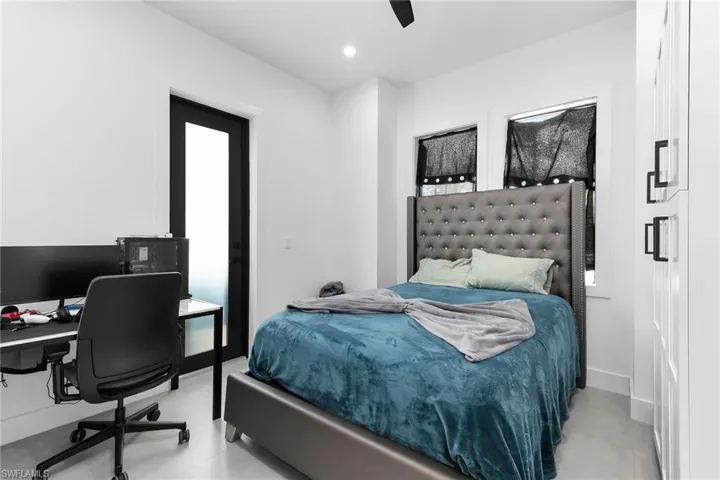 Bedroom with an office area, ceiling fan, and recessed lighting