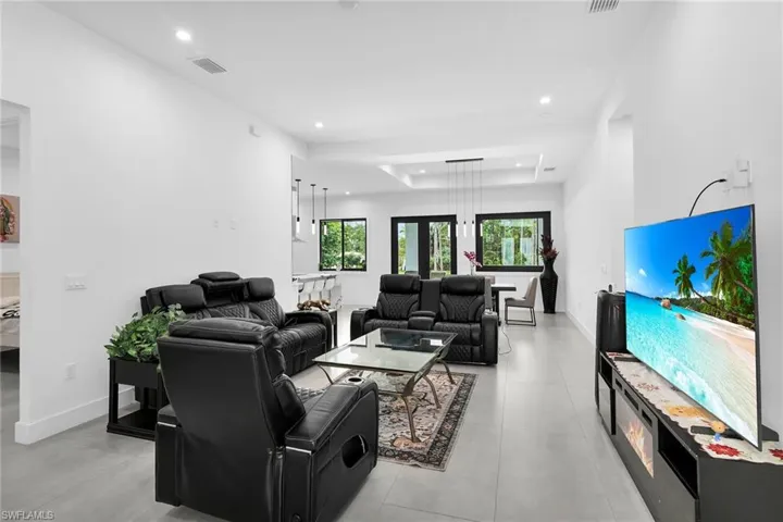 Living room with a raised ceiling and recessed lighting