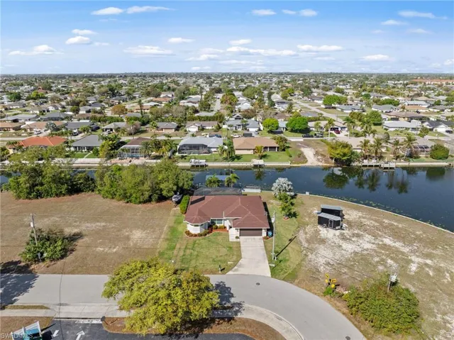 Aerial perspective of suburban area featuring a nearby body of water