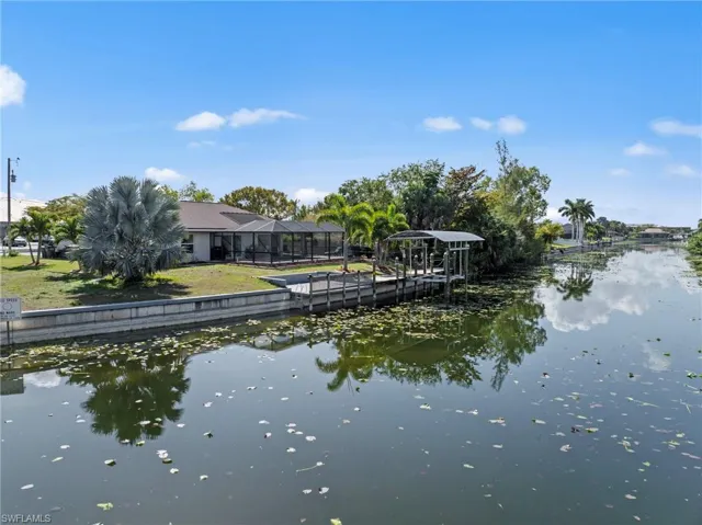 Dock featuring a water view and glass enclosure