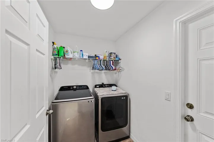 Laundry room with washing machine and dryer and baseboards